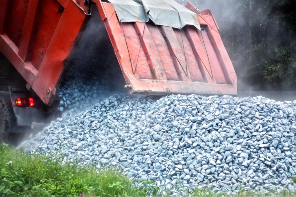 Pile of gray landscaping gravel for a driveway or path after using a gravel calculator to determine the quantity required for the job.