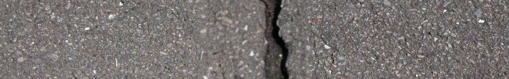 Cracked concrete sidewalk with visible crack running across the surface. How to repair sidewalk cracks