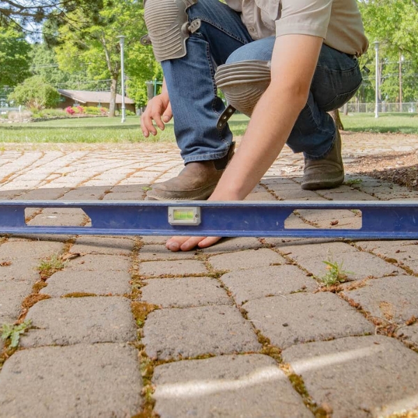 checking paver patio level during repair