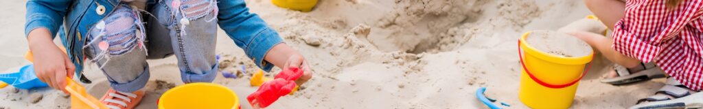 children playing in sandbox with colorful toys and play sand. Used in sand calculator