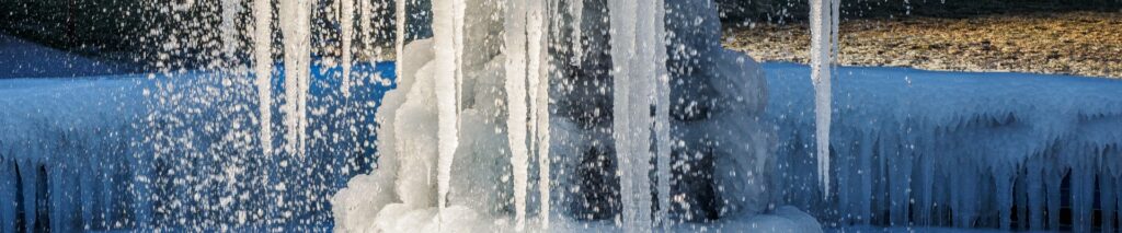 how to winterize your sprinkler system showing frozen pipes with ice damage from skipping winterization