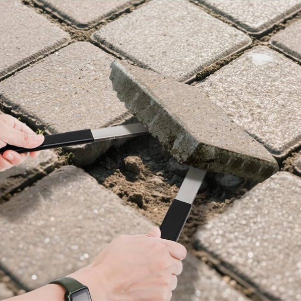 lifting a sunken paver with a paver puller tool