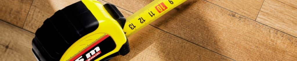 tape measure on hardwood floor for square footage calculator