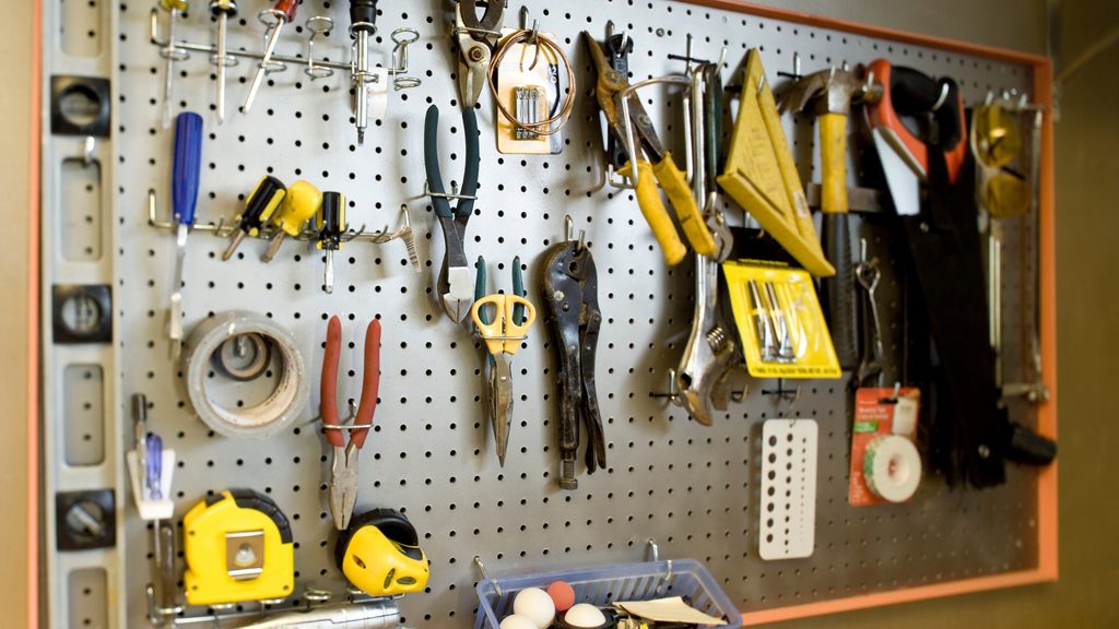 garage pegboard organizer with tools, hooks, and bins mounted on wall