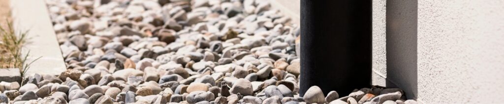 how to install a French drain — gravel drainage channel along a house foundation