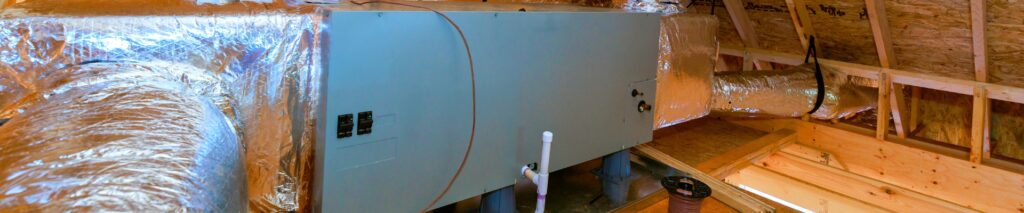 clogged AC drain line — attic air handler with PVC condensate drain pipe visible