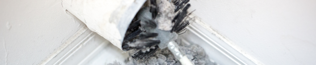 Dryer vent cleaning brush pushing large amounts of lint out of a dryer duct. How to clean a dryer vent