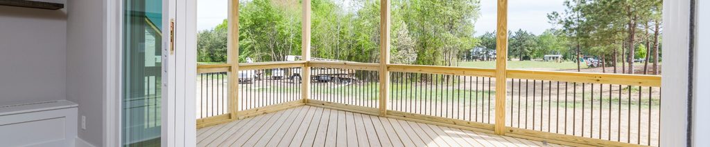 Clean restored wood deck with sliding glass door and outdoor ceiling fan showing finished result. How to clean a wood deck