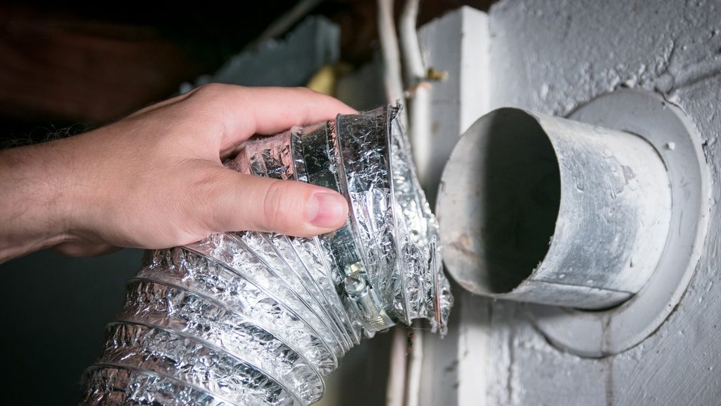 Hand disconnecting a flexible foil dryer vent duct from the wall opening