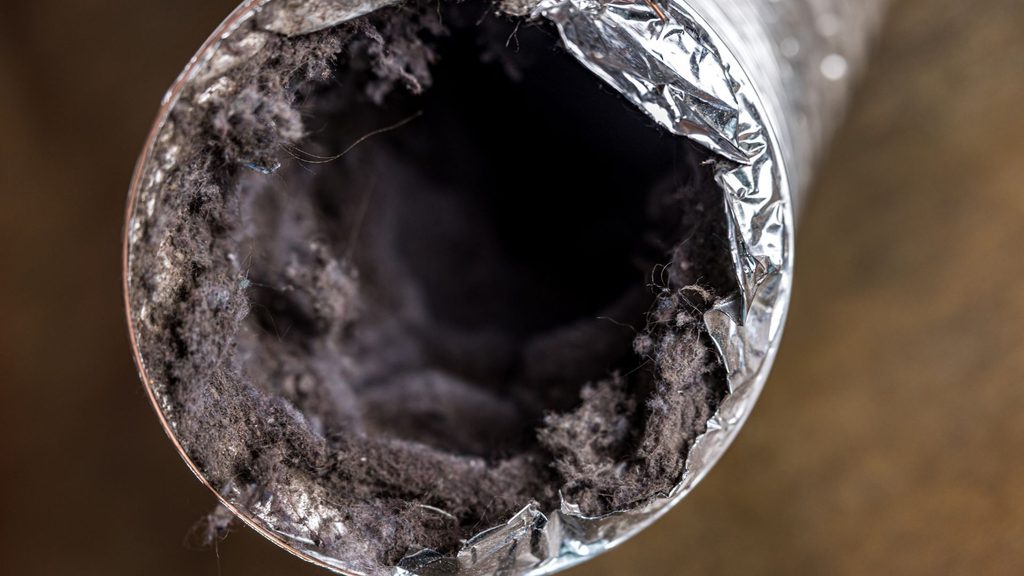 Inside view of a dryer vent duct heavily clogged with lint buildup