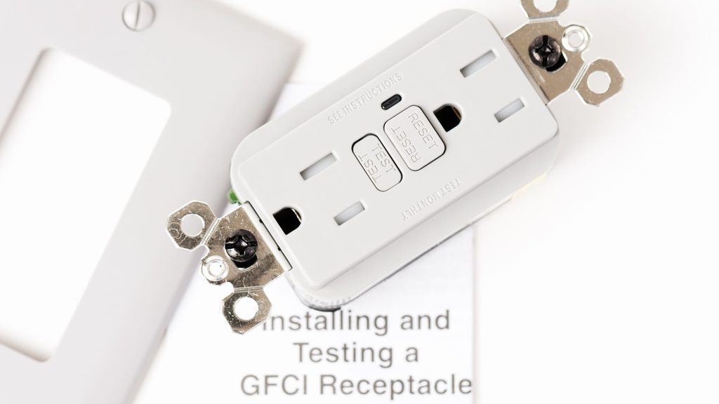 new GFCI receptacle with wall plate and installation instructions