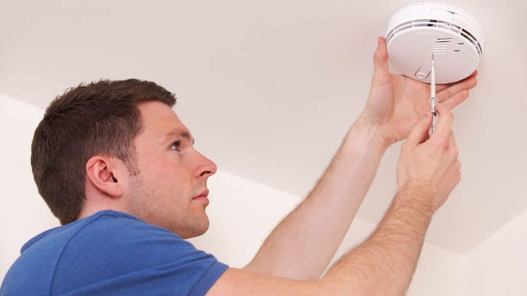 testing smoke detectors as part of winter home maintenance